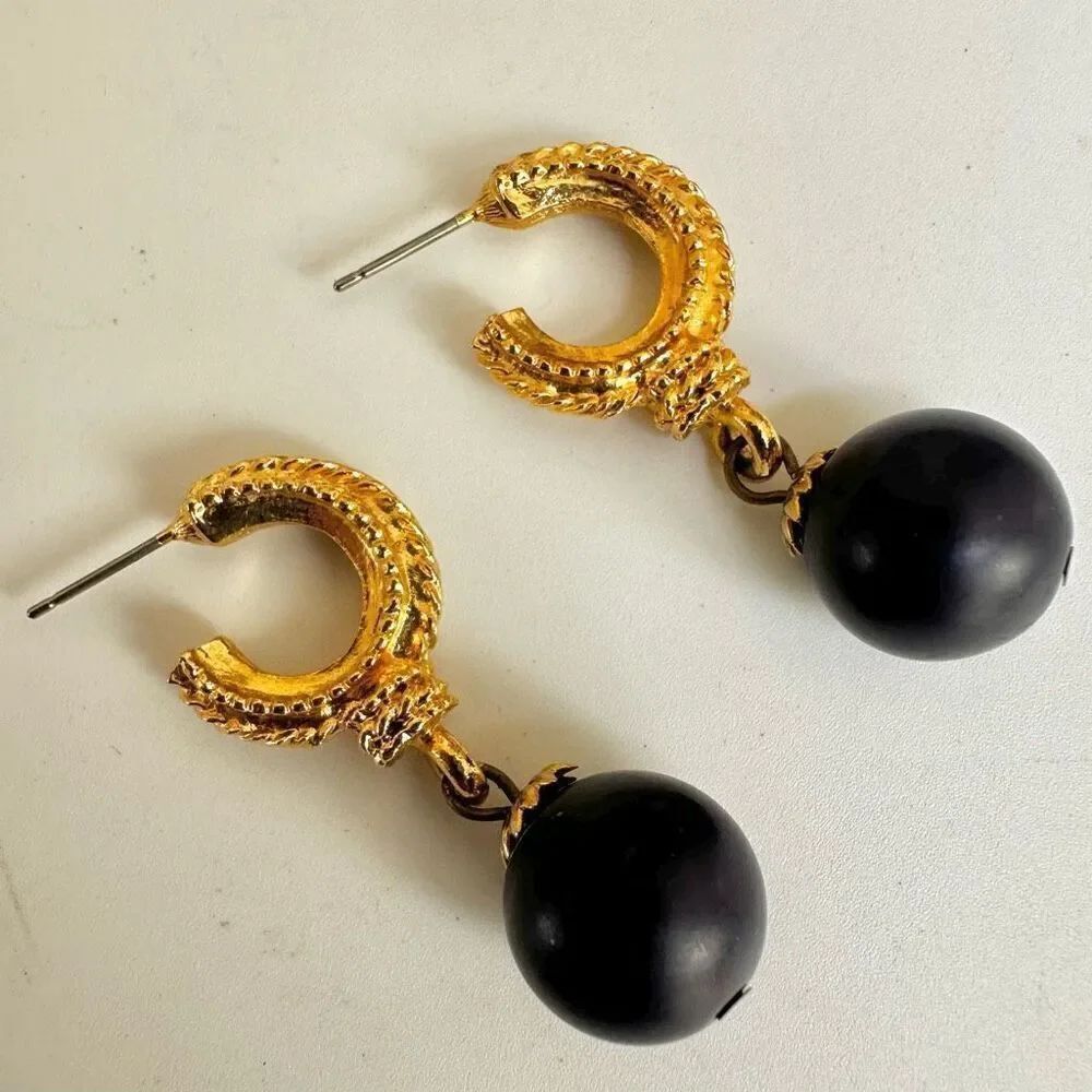 Gold hoop earrings with purple ball drop